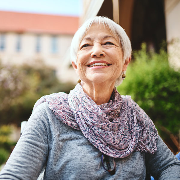 An aged woman is happy after receiving a successful kyphoplasty treatment in DFW Metro Area