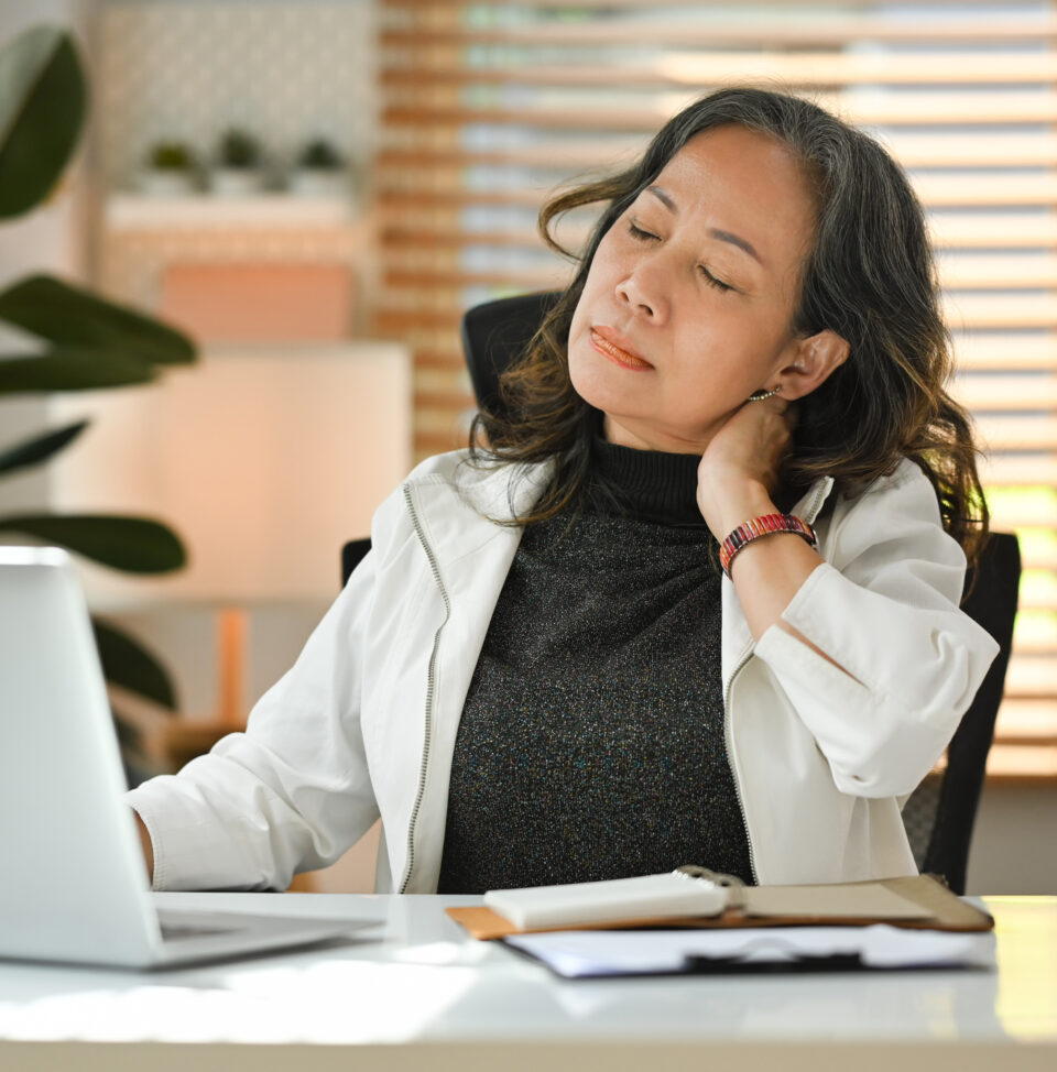 businesswoman rubbing neck